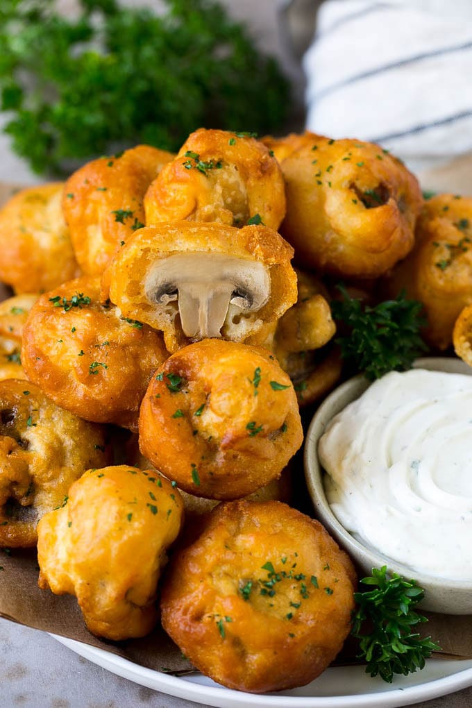 Un plato de champiñones fritos servido con salsa ranchera.
