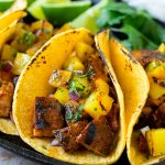 Tacos al pastor rellenos de cerdo a la plancha, piña, cebolla morada y cilantro.