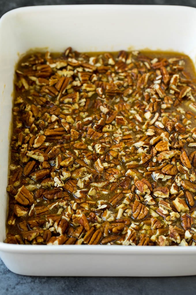 Receta de bollos pegajosos | Sándwiches dulces | Rollos de canela # desayuno # brunch # canela # nueces # Cazuelas online# pan Caramelo y nueces en el fondo de una fuente para hornear.