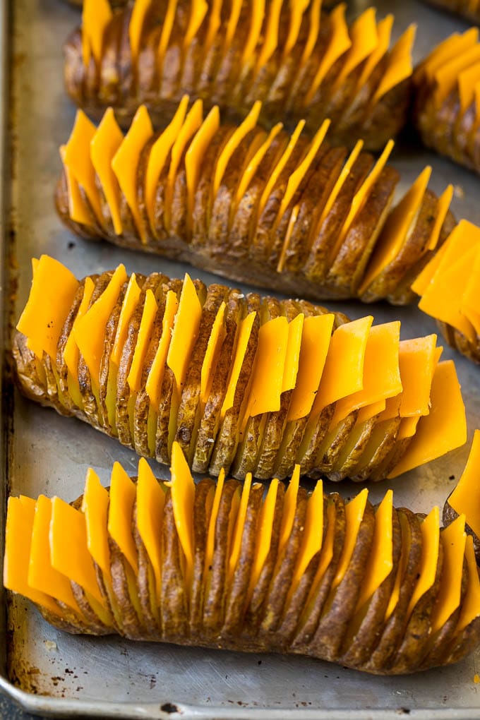 Patatas en rodajas finas con rodajas de queso entre cortes.