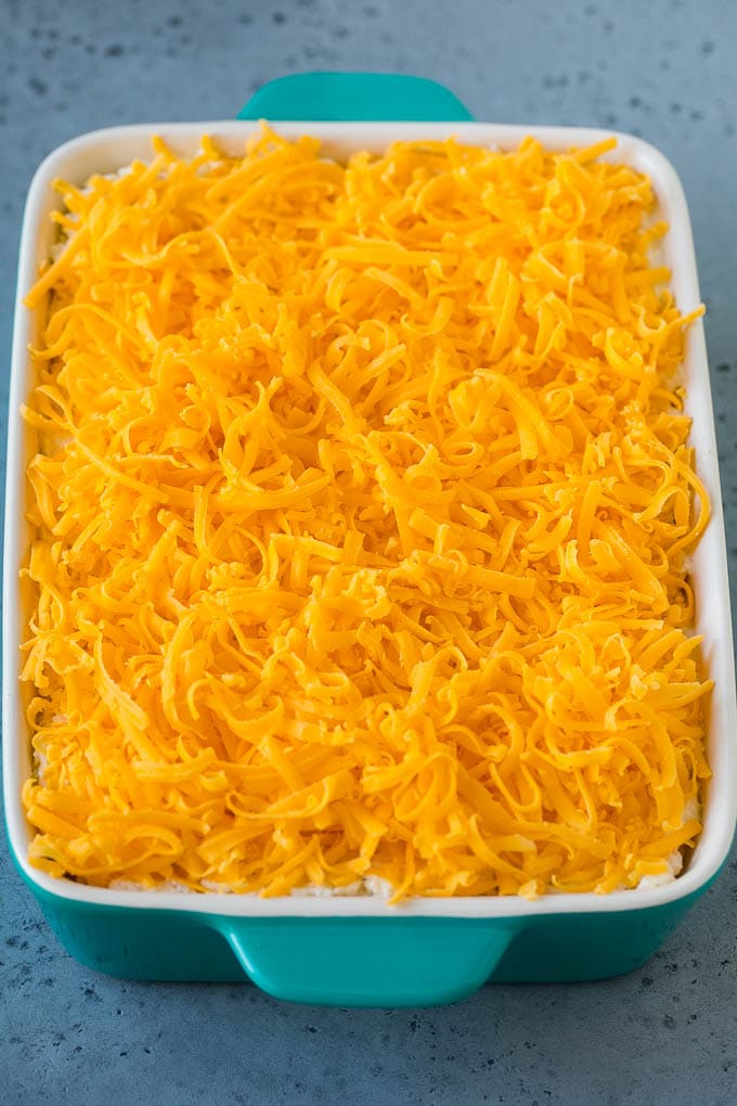 ¡Una cazuela de patatas fritas cubiertas con queso cheddar rallado!