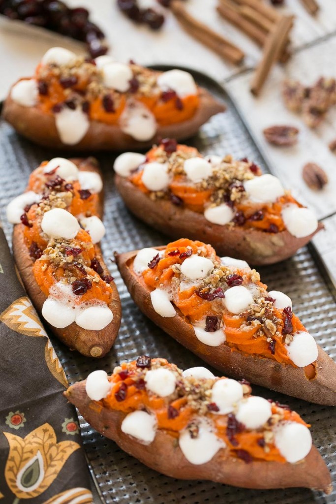 Estas batatas de doble carga se rellenan con streusel de nueces con azúcar morena, malvaviscos y arándanos secos.  ¡Puede prepararlos con anticipación y ponerlos en el horno justo antes de la comida navideña!