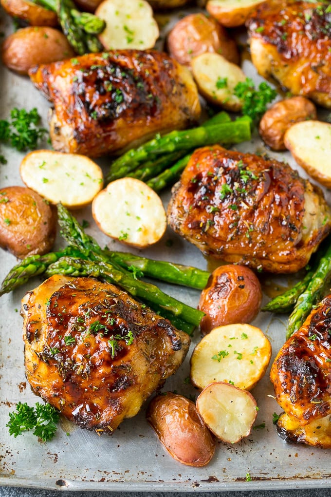 Receta de pollo balsámico | Pollo en un plato | Pollo glaseado # pollo # espárragos # papas # cena # sin gluten #dinneratthezoo Una sartén con pollo balsámico, patatas rojas y ramitas de espárragos.