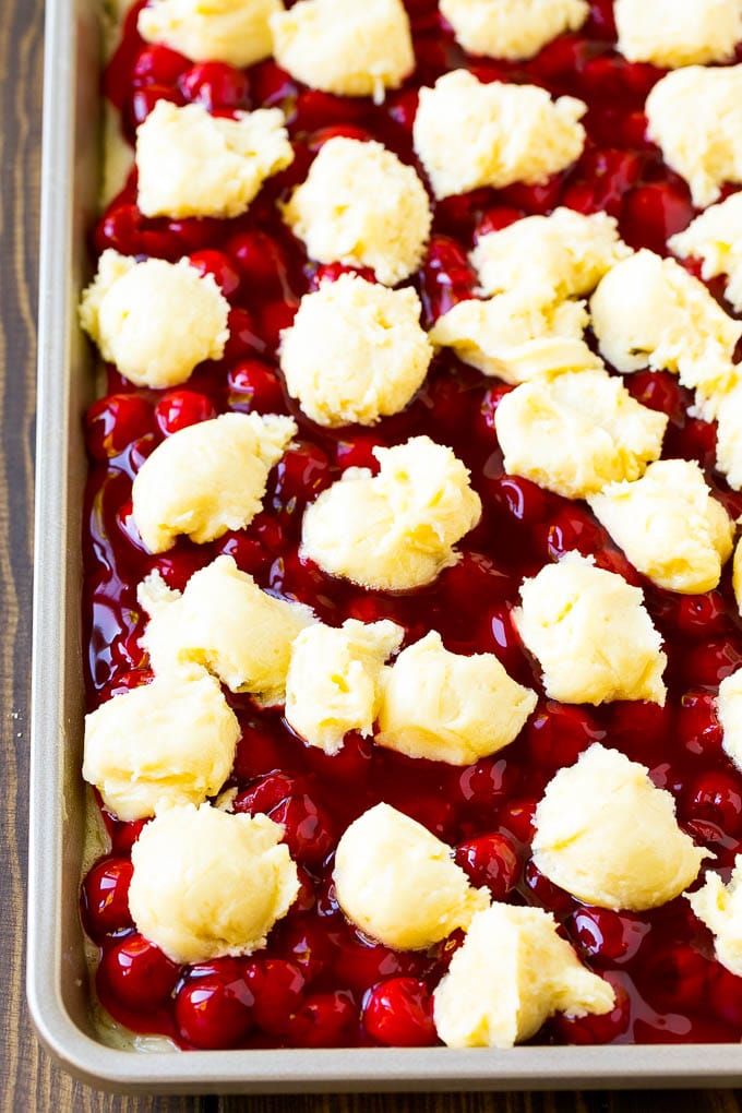 Pastel de cerezas relleno con cucharadas de masa de galleta por encima.