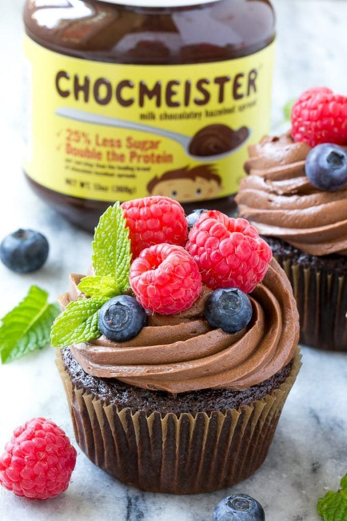 Cupcakes de nutella con glaseado cremoso, frambuesas y arándanos.