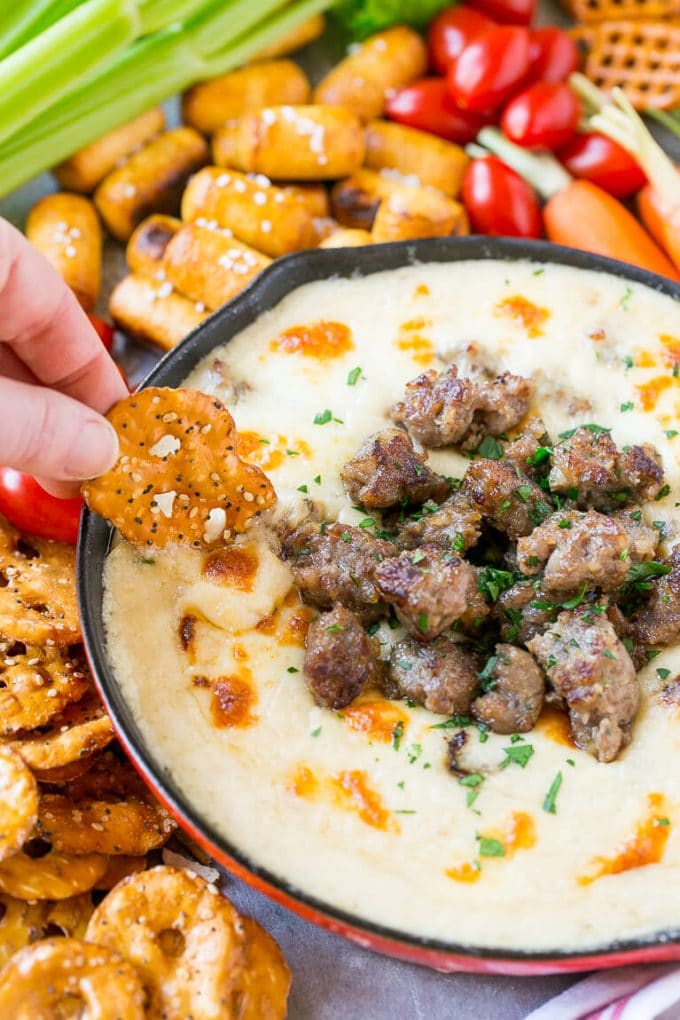 Una patata frita que recoge una salsa de queso y cerveza.